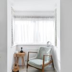 Minimalist reading nook with chair and window.