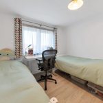 Cosy bedroom with twin beds and study desk.