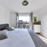 Modern bedroom with balcony view.