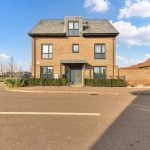 Modern brick house with front garden and street view.