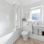 Modern white bathroom with bathtub and sink