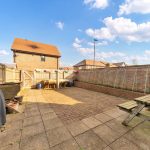 Sunny brick patio with wooden picnic table