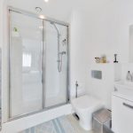 Modern white bathroom with shower and toilet