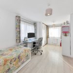 Bright children's bedroom with desk and storage boxes