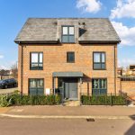 Two-storey brick house on a sunny day.