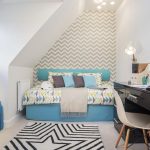 Stylish modern bedroom with geometric patterns and desk.