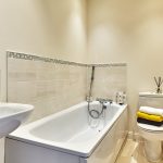 Modern bathroom with bathtub and sleek decor.