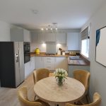 Modern kitchen with dining table and appliances