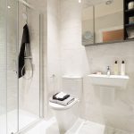 Modern bathroom with shower and tiled walls.