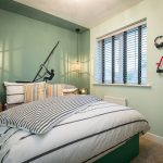 Stylish bedroom with striped bedding and decor accents.