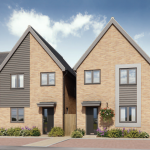 Modern semi-detached brick houses with cars and plants.