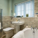 Modern bathroom with towels and toiletries.