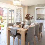 Modern dining room with wooden table and chairs.