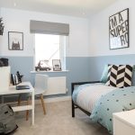 Modern blue and white child's bedroom with desk.