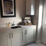 Modern kitchen with sink and storage cupboards.