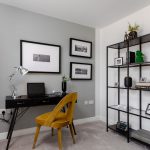 Modern home office with desk and shelving.