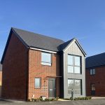 Modern two-storey brick house under blue sky