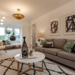 Modern living room with stylish decor and large window.