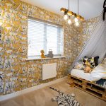 Children's room with animal wallpaper and teepee bed.