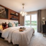 Cosy modern bedroom with elegant decor and window view.