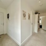 Modern home hallway with carpet and artwork