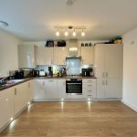 Modern kitchen with appliances and wooden floor