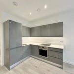 Modern grey kitchen with built-in appliances.