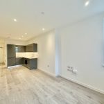 Modern flat with open-plan kitchen and living space.