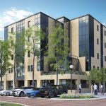 Modern office building with parked cars and trees.