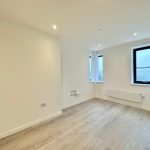 Empty room with wooden floor and windows