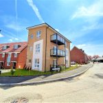 Modern residential housing development under blue sky.