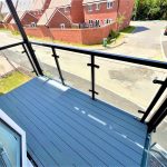 Modern balcony overlooking residential street view.