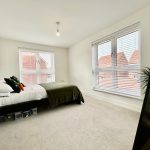 Bright bedroom with double bed and windows