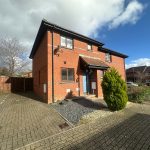 Brick house with drive and front garden