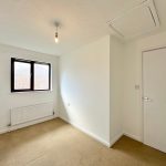 Empty room with carpet and window.