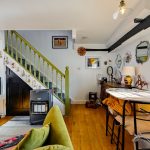 Cosy living room with green staircase and decor