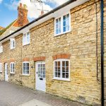 Stone terraced houses on a quiet street.