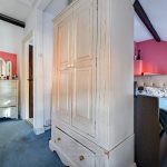 Cosy bedroom with vintage white furniture.