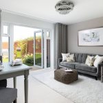 Modern living room with grey sofa and dining area.