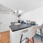 Modern kitchen with island and bar stools.