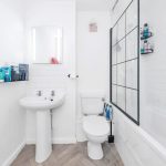 Modern bathroom with sink, toilet, and bathtub