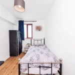 Bright single bedroom with wooden floor