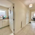 Hallway with kitchen and office doors open.