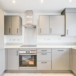 Modern kitchen with grey cabinets and oven