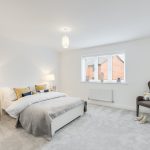 Modern bedroom with neutral decor and natural light.