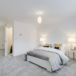 Modern white bedroom with ensuite bathroom.