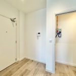 White hallway with electrical panel cupboard.