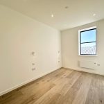 Empty room with wooden floor and window