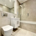 Modern bathroom with glass-enclosed shower and toilet