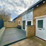 Modern patio with decking and double patio doors.